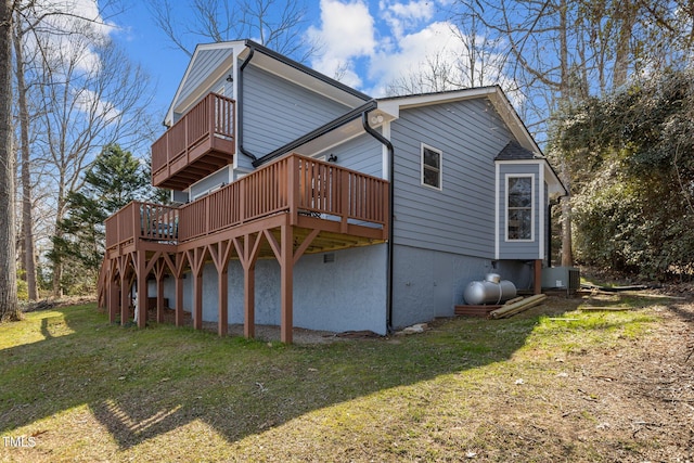 view of property exterior with a yard and central AC