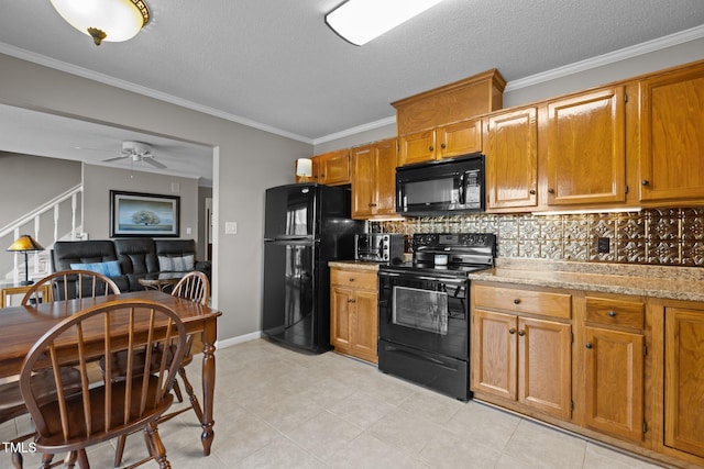 kitchen with brown cabinetry, backsplash, black appliances, and crown molding