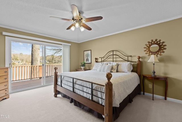 carpeted bedroom with a textured ceiling, access to exterior, and ornamental molding