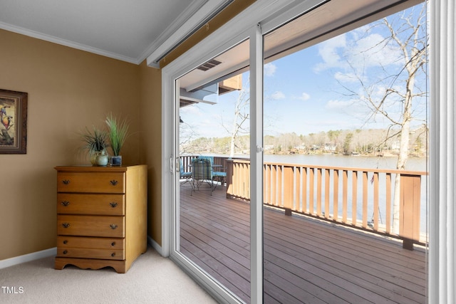 doorway featuring light colored carpet, crown molding, baseboards, and a water view