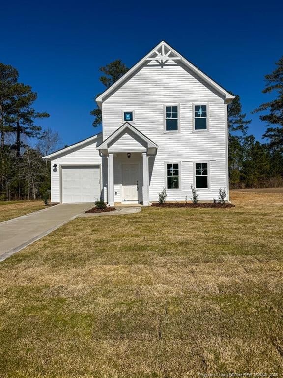 view of front facade with driveway, a front lawn, and an attached garage