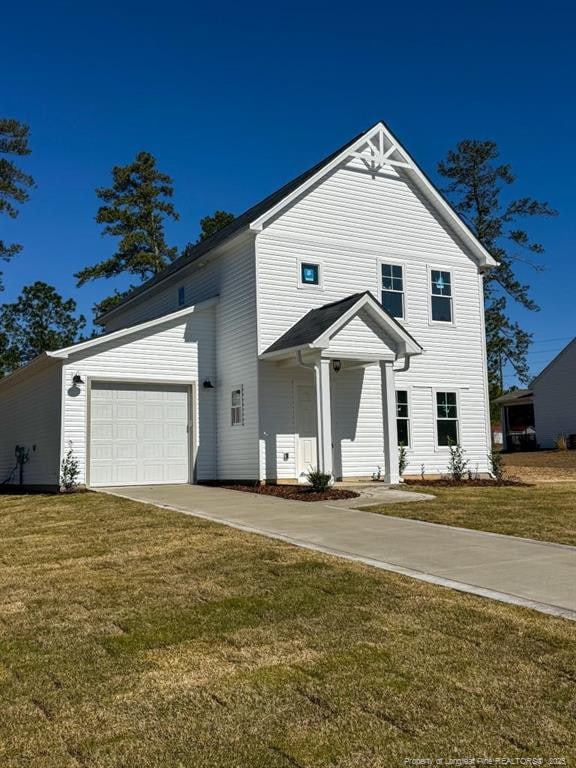 view of front of house featuring a front lawn, an attached garage, and concrete driveway