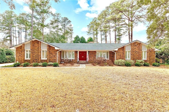 ranch-style home with brick siding and a front lawn