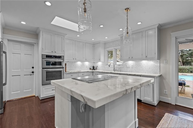 1906 Partridge Dr, Fayetteville, NC 28304 - kitchen featuring stainless steel double oven, black electric stovetop, crown molding, and white cabinetry