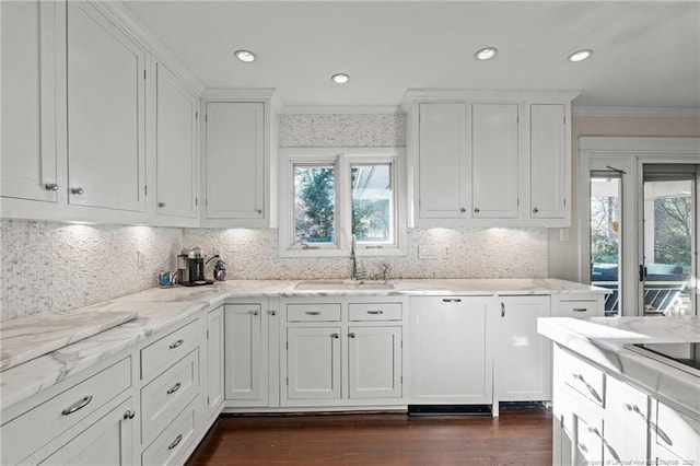 1906 Partridge Dr, Fayetteville, NC 28304 - kitchen with crown molding, white cabinets, light stone counters, and a sink