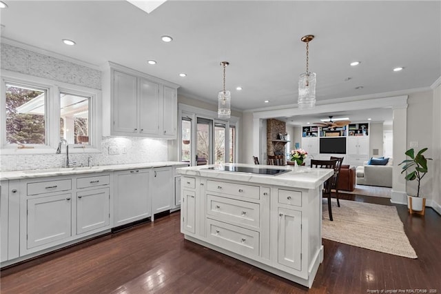 1906 Partridge Dr, Fayetteville, NC 28304 - kitchen featuring a sink, black electric cooktop, plenty of natural light, and crown molding