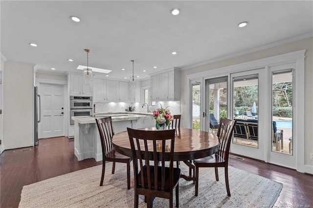 1906 Partridge Dr, Fayetteville, NC 28304 - dining space with dark wood finished floors, recessed lighting, a skylight, and ornamental molding