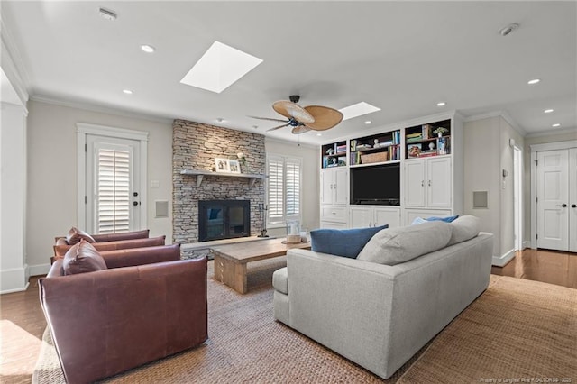 1906 Partridge Dr, Fayetteville, NC 28304 - living area featuring wood finished floors, recessed lighting, a fireplace, and ornamental molding