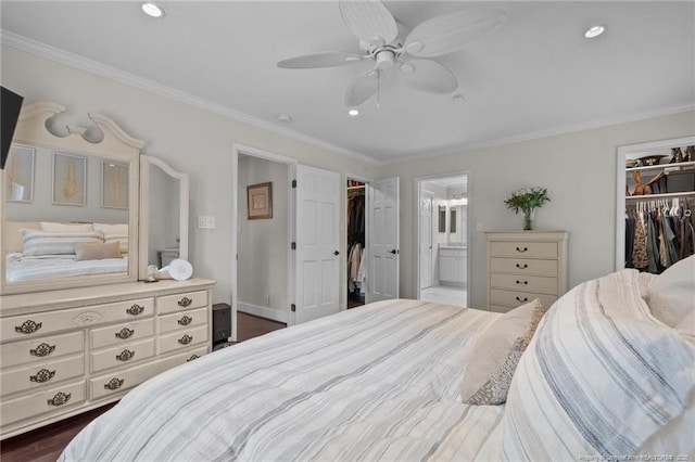 1906 Partridge Dr, Fayetteville, NC 28304 - bedroom featuring a walk in closet, dark wood finished floors, a closet, and ornamental molding