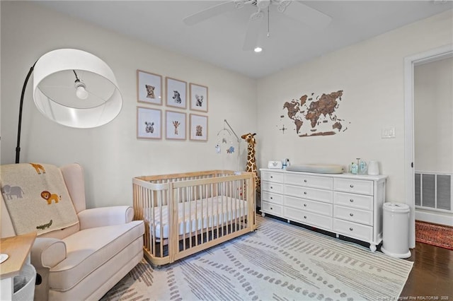 1906 Partridge Dr, Fayetteville, NC 28304 - bedroom with ceiling fan, visible vents, a nursery area, and wood finished floors