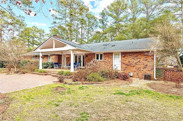 1906 Partridge Dr, Fayetteville, NC 28304 - rear view of house featuring a patio area, a yard, a shingled roof, and brick siding