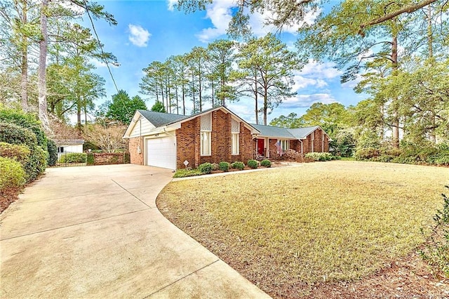 1906 Partridge Dr, Fayetteville, NC 28304 - view of front of property featuring a front yard, brick siding, concrete driveway, and an attached garage