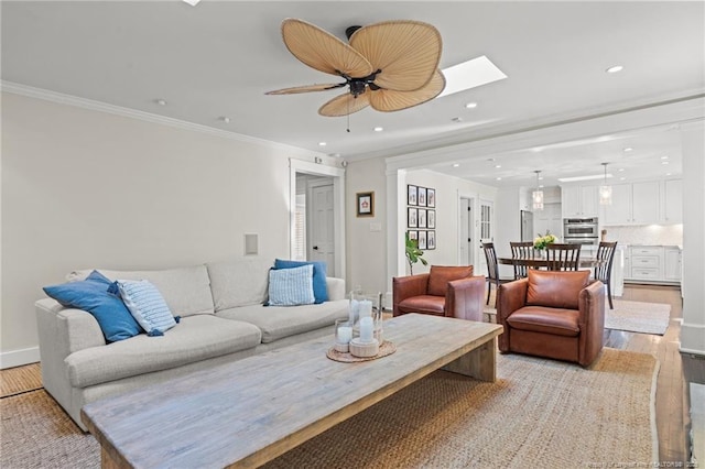 1906 Partridge Dr, Fayetteville, NC 28304 - living area with light wood finished floors, recessed lighting, ornamental molding, ceiling fan, and a skylight