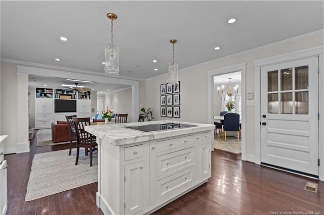 1906 Partridge Dr, Fayetteville, NC 28304 - kitchen with black electric cooktop, ornamental molding, white cabinets, a chandelier, and dark wood-type flooring