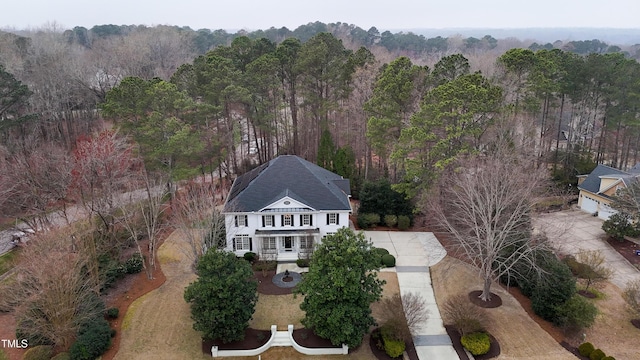 bird's eye view with a wooded view