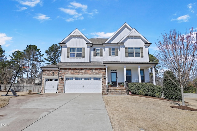 view of front of house featuring driveway, covered porch, stone siding, a garage, and board and batten siding