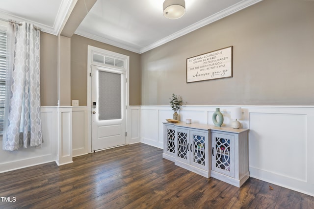 entrance foyer featuring wood finished floors, wainscoting, and ornamental molding