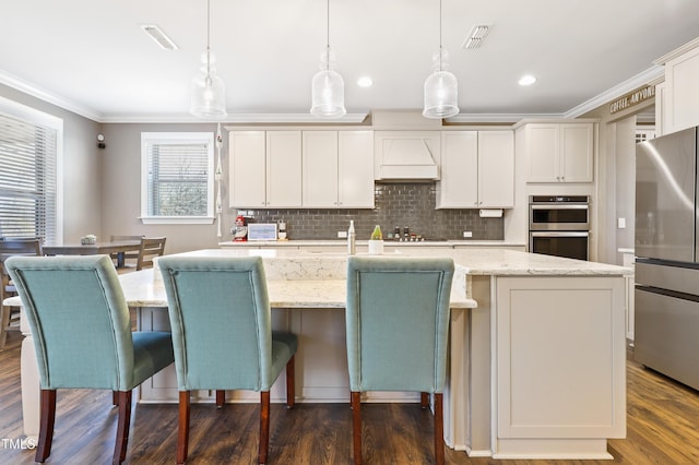 kitchen featuring custom range hood, appliances with stainless steel finishes, crown molding, decorative backsplash, and dark wood-style flooring