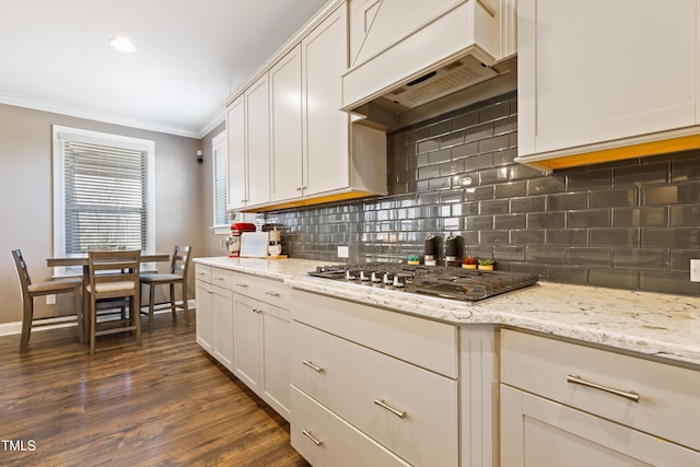 kitchen with premium range hood, dark wood-style flooring, stainless steel gas stovetop, crown molding, and tasteful backsplash