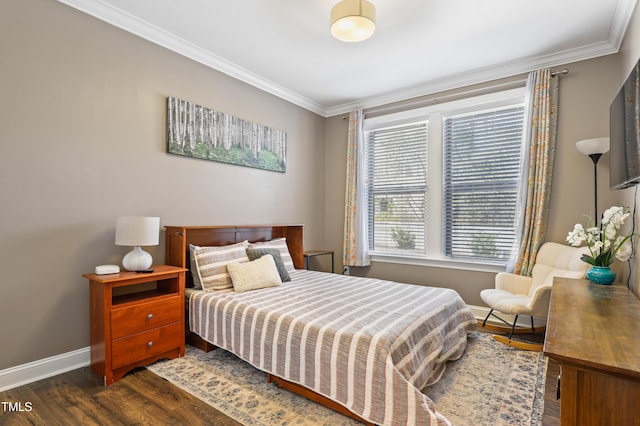 bedroom featuring dark wood finished floors, crown molding, and baseboards