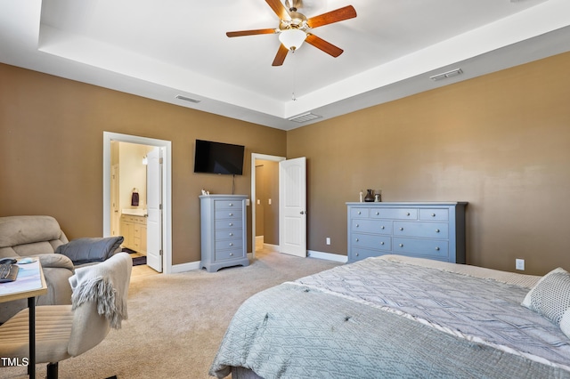 bedroom featuring a tray ceiling, baseboards, and visible vents