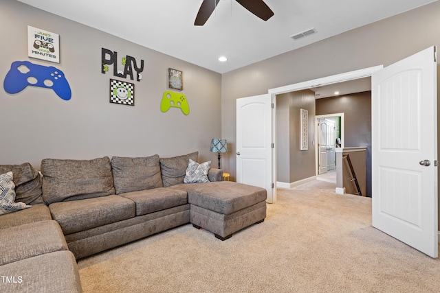 living area featuring a ceiling fan, visible vents, baseboards, recessed lighting, and light colored carpet