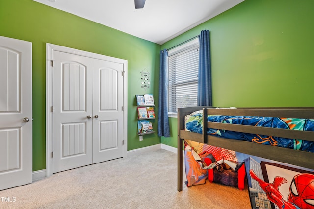 bedroom with a closet, ceiling fan, baseboards, and carpet floors