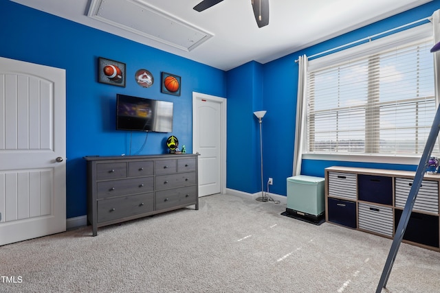 bedroom with attic access, baseboards, carpet floors, and ceiling fan