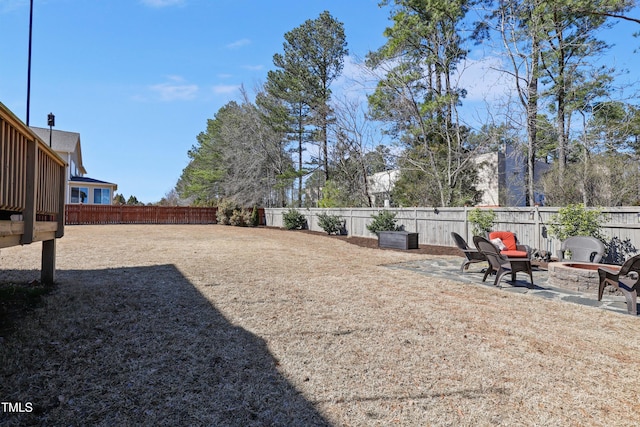 view of yard featuring a patio, an outdoor fire pit, and a fenced backyard