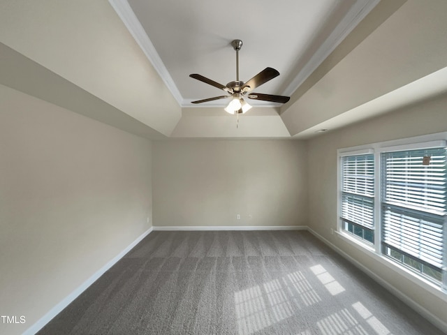 unfurnished room with ceiling fan, carpet, a raised ceiling, and baseboards