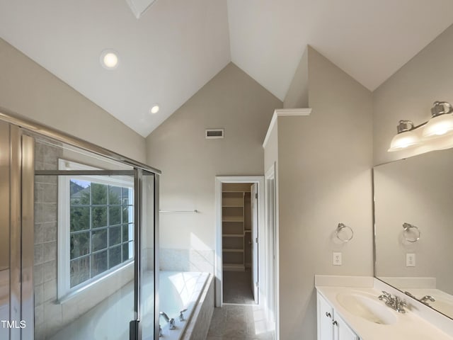 full bath featuring a spacious closet, visible vents, high vaulted ceiling, a bath, and vanity