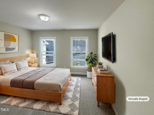 carpeted bedroom featuring baseboards