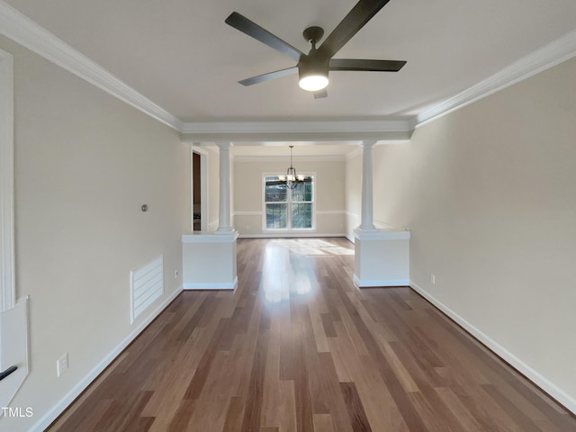 interior space featuring crown molding, decorative columns, wood finished floors, and visible vents