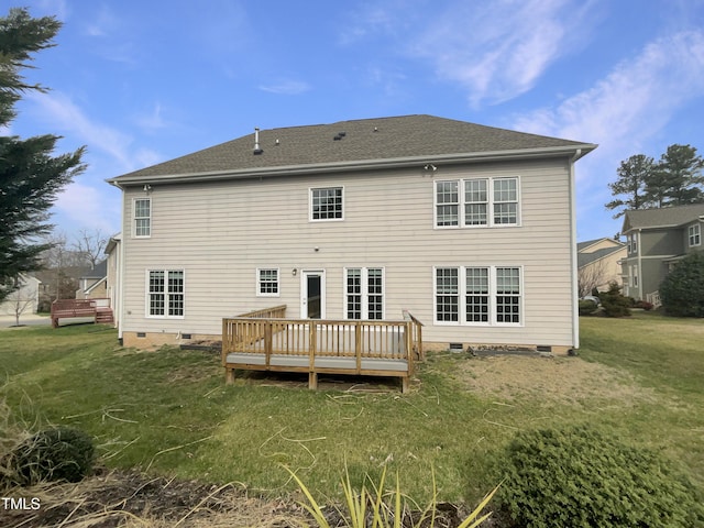 rear view of property featuring crawl space, a lawn, a wooden deck, and roof with shingles