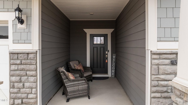 doorway to property with stone siding