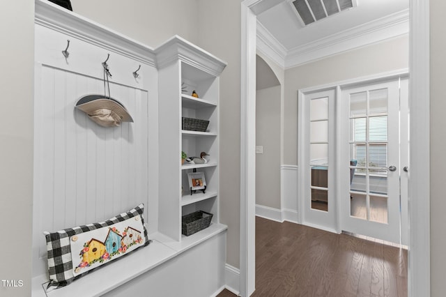 mudroom with visible vents, built in shelves, crown molding, baseboards, and dark wood finished floors