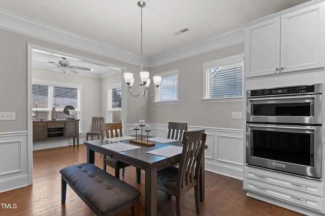 dining area with visible vents, dark wood-style floors, wainscoting, and ornamental molding