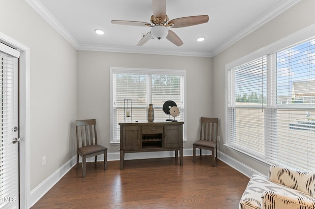 living area with crown molding, dark wood-style floors, baseboards, and ceiling fan