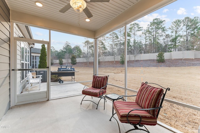 sunroom / solarium featuring ceiling fan