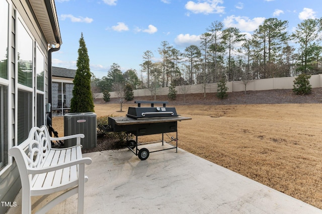 view of patio / terrace featuring area for grilling, central AC unit, and a fenced backyard