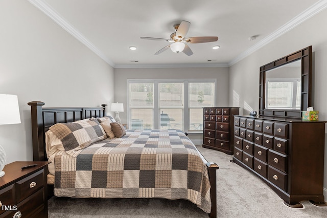 bedroom featuring light colored carpet, ornamental molding, and a ceiling fan