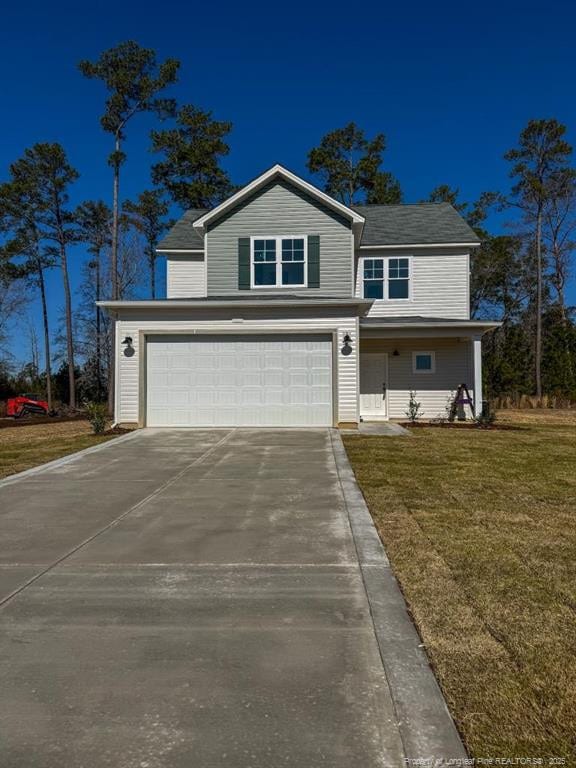 traditional home featuring a garage, concrete driveway, and a front lawn