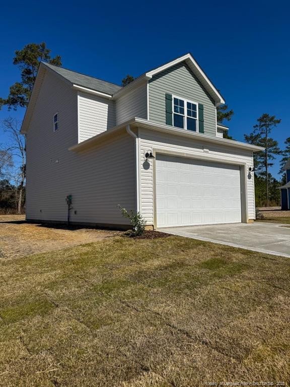 view of front facade featuring driveway, a front lawn, and an attached garage