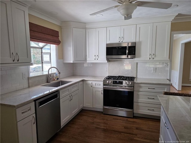 kitchen with dark wood finished floors, ceiling fan, a sink, white cabinets, and appliances with stainless steel finishes