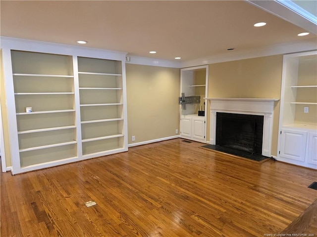 unfurnished living room featuring recessed lighting, a fireplace, and wood finished floors