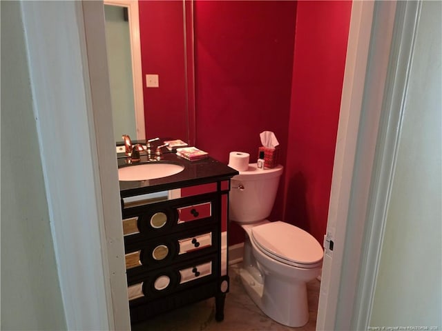 half bath featuring toilet and vanity