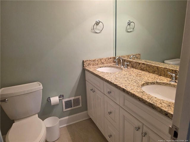 bathroom with double vanity, toilet, visible vents, and a sink