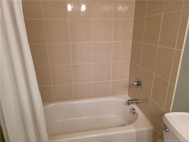 full bath with toilet and shower / bath combo with shower curtain