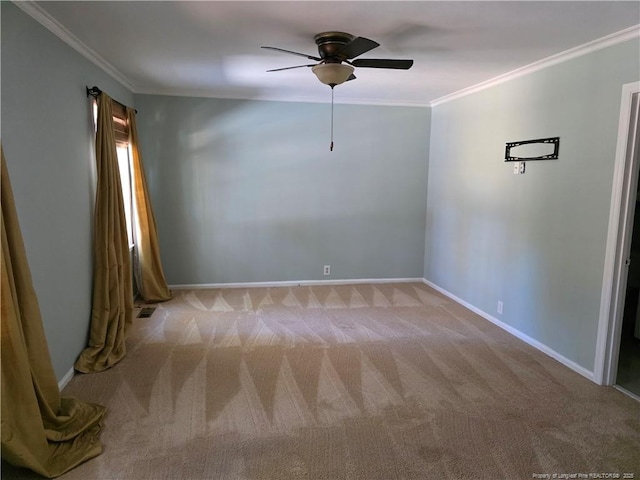 carpeted empty room featuring visible vents, a ceiling fan, baseboards, and ornamental molding