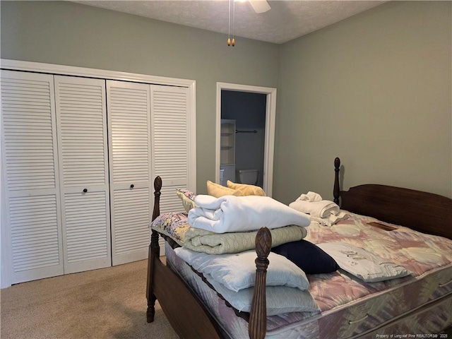 bedroom featuring a closet and light colored carpet